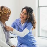 Home care nurse assisting a patient with healthcare support