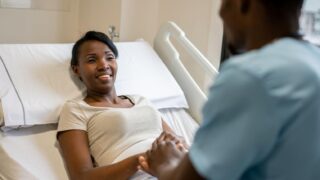 Compassionate Black nurse providing healthcare support and patient care for women’s wellness.